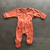 Flay Lay of the front of the sleepsuit in Red Clay