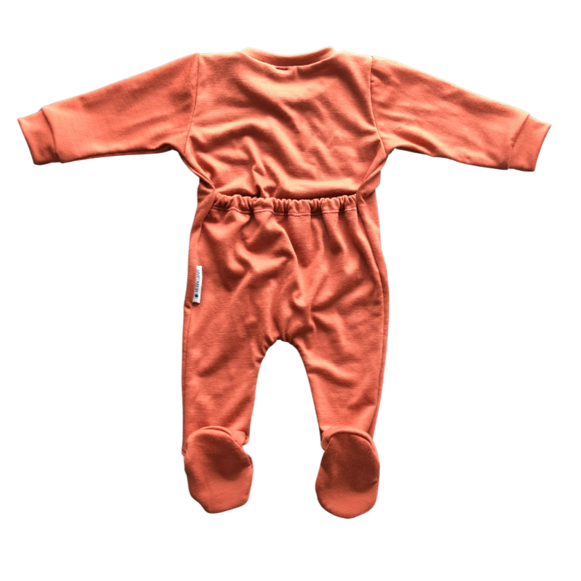 Flat lay of the back of a baby grow with feet